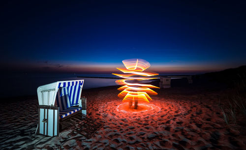 Illuminated lamp post at night