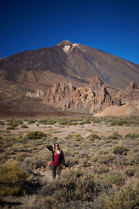 Full length of man standing on arid landscape
