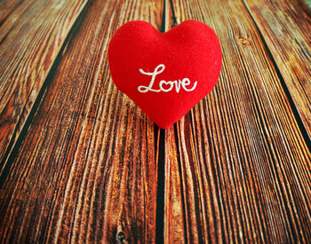 Close-up of heart shape made of text on wood