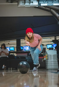 Professional female bowler throws his throw and is in position to watch his ball. bowling life. 