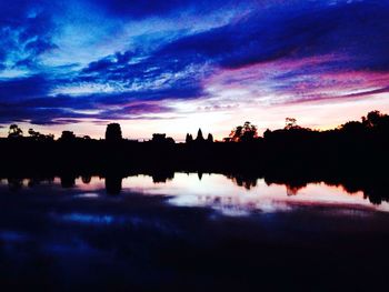 Scenic view of lake against romantic sky at sunset