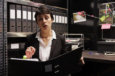 Portrait of businesswoman using mobile phone in office