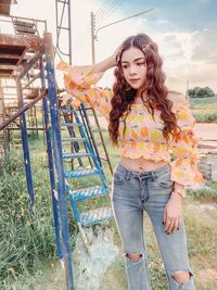 Beautiful young woman standing on field