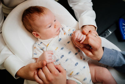 High angle view of baby holding mother
