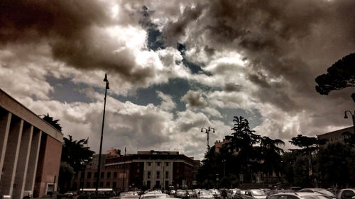 Buildings against cloudy sky