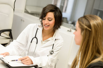 Female doctor discussing with patient at hospital