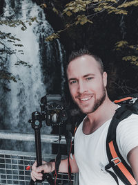 Portrait of young man photographing
