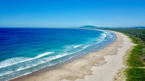 Scenic view of sea against sky and a long spanning beach