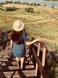 Rear view of woman walking on steps