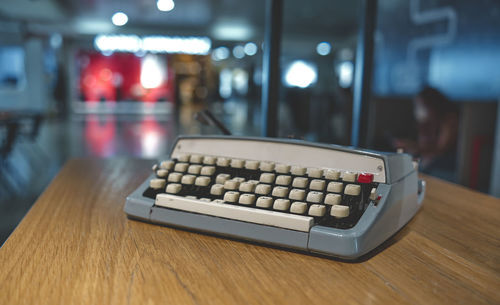 Retro old typewriter on blur background and front of wooden table. vintage concept.
