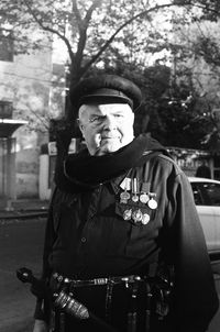 Portrait of man wearing hat in city