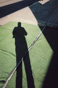 Shadow of person on golf course