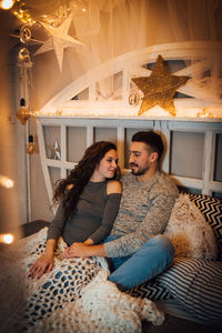 Young couple sitting at home