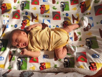 Cute boy playing on bed at home