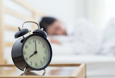 Close-up of man sleeping on table