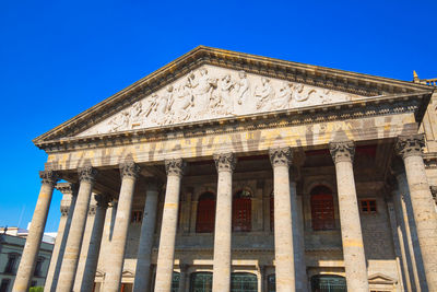 Low angle view of building against blue sky