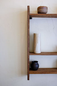 Close-up of electric lamp hanging on wall at home