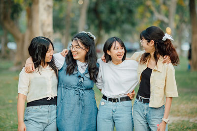 Group of friends standing against the wall