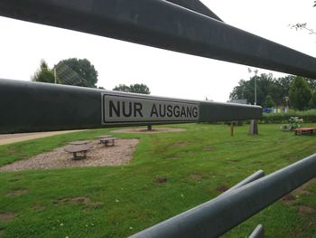 Close-up of sign on grass