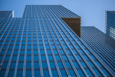 Low angle view of modern building against clear blue sky