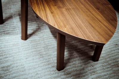 High angle view of wooden table on carpet at home