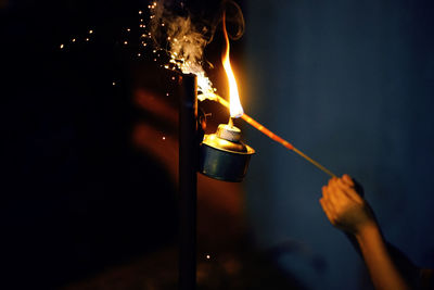 Close-up of person igniting incense 