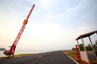 Crane at construction site against sky