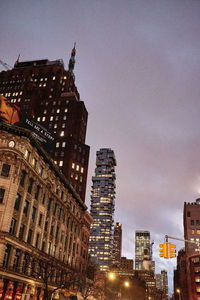 Low angle view of illuminated buildings against sky at night