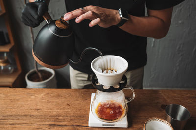 Barista dripping coffee and slow coffee wooden bar style