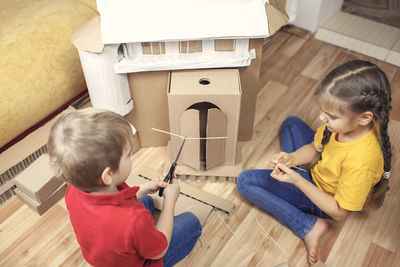 High angle view of people sitting on wooden floor