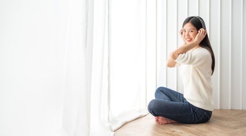 Portrait of a smiling young woman at home