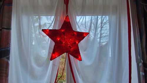 Close-up of christmas decorations on window