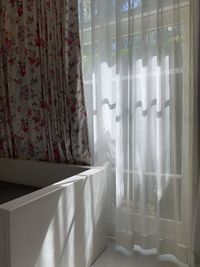 White curtain hanging on window at home