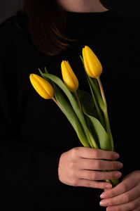 Midsection of woman holding plant