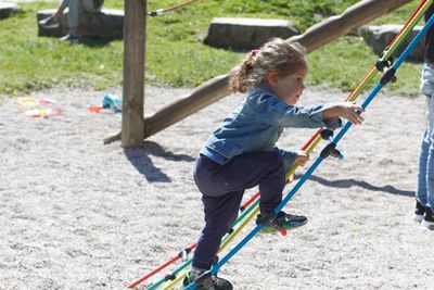 Full length of girl playing on playground