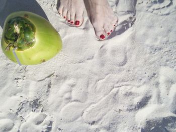 High angle view of woman and apple on sand