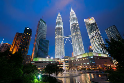Low angle view of skyscrapers lit up at night