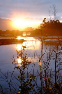 Scenic view of lake against sky during sunset