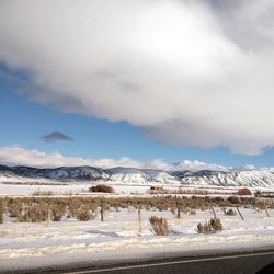 Snow covered land against sky