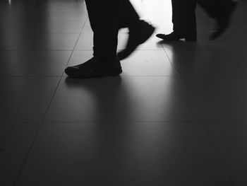 Low section of woman standing on tiled floor