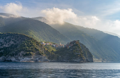 Scenic view of sea and mountains against sky