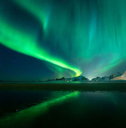 Scenic view of lake against sky at night