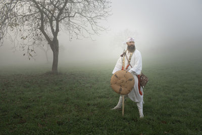 Full length of man walking on field