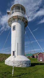 Low angle view of lighthouse against cloudy sky