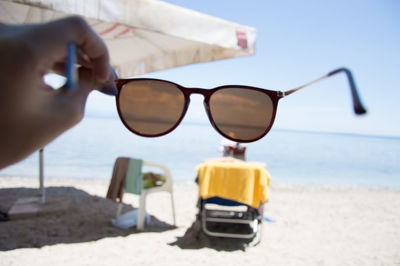 Close-up of young woman on sunglasses at beach