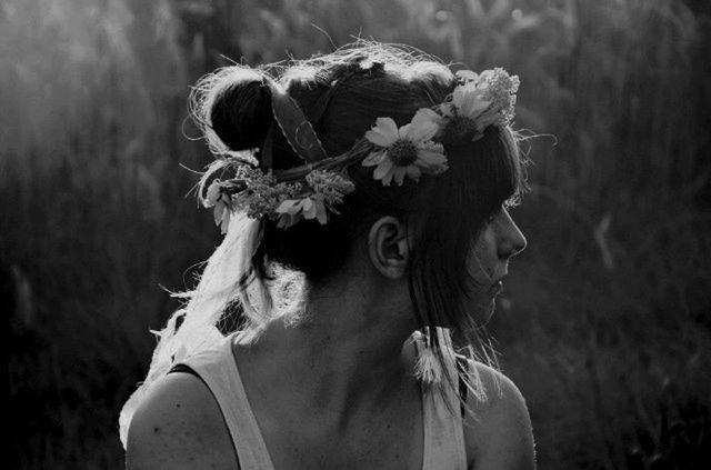 YOUNG WOMAN WITH FLOWERS IN MOUTH