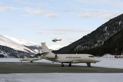 Private jets and an jet airplane taking off in the airport of st moritz switzerland in winter