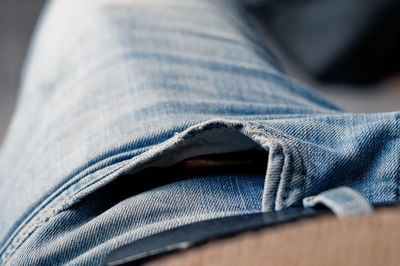 Midsection of man in jeans at home