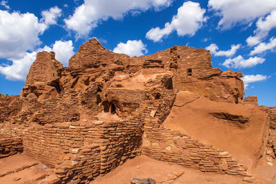 Rock formations against cloudy sky