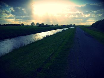 Scenic view of agricultural field against sky during sunset